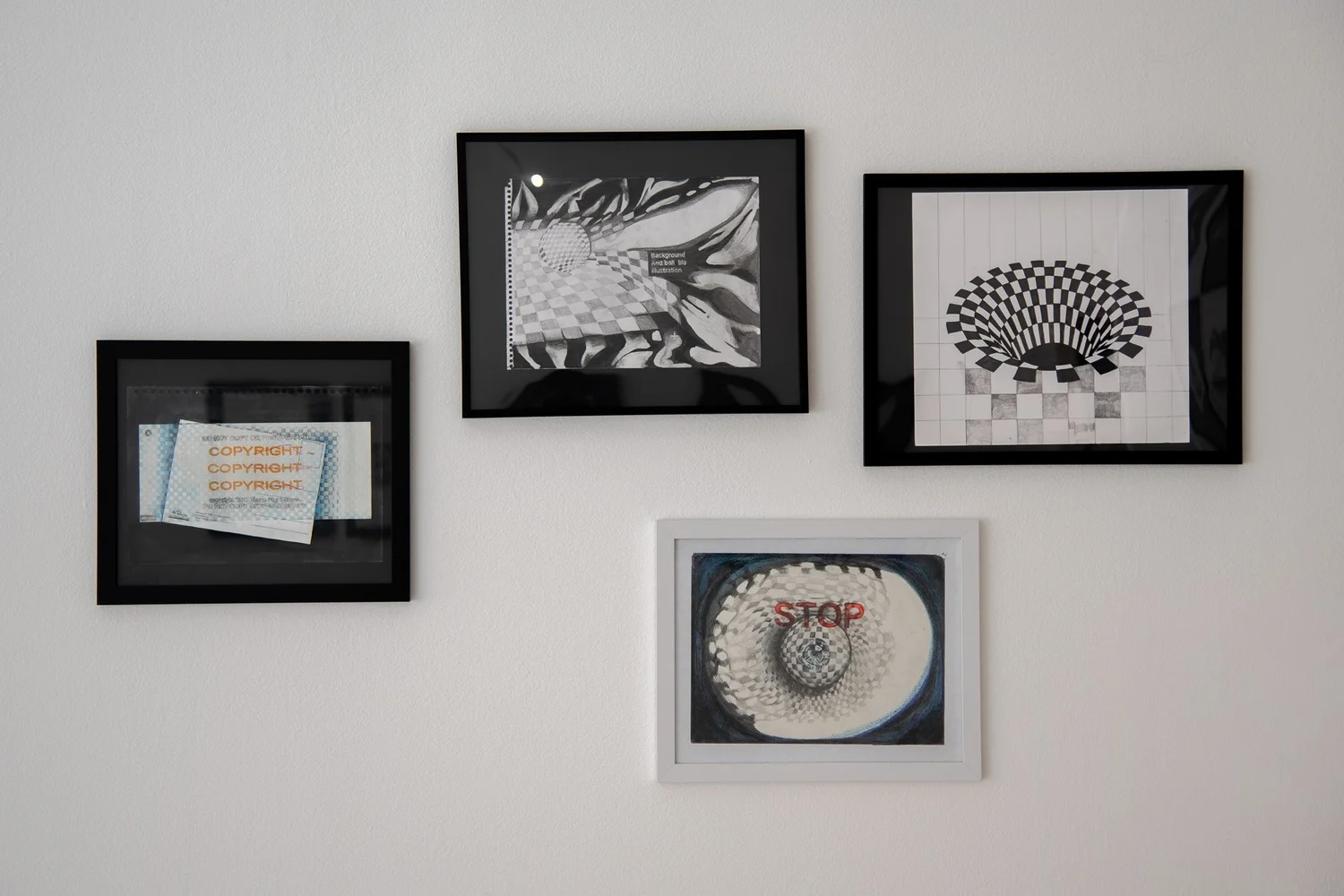Gallery wall with four framed black-and-white optical illusion prints, including a checkered vortex and 'STOP' artwork.