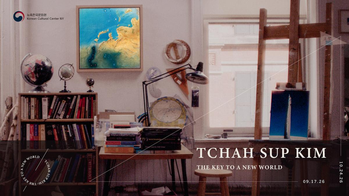 Exhibition poster “The Key to a New World” at Korean Cultural Center NY in an art studio with books, globes, and easel.