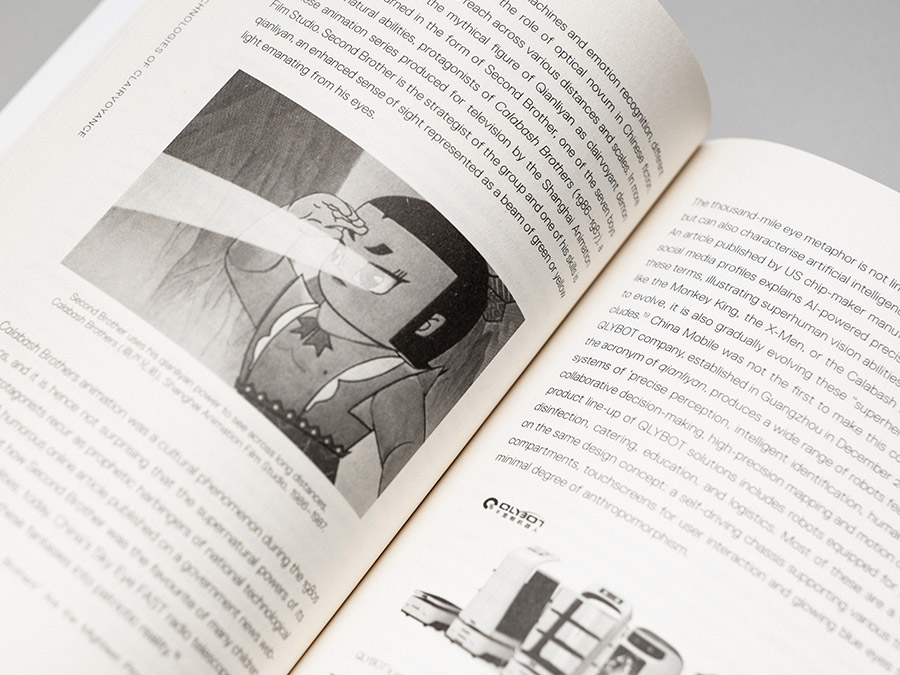 Open book with text and black-and-white cartoon illustration of a boy shooting a light beam from his eyes, close-up
